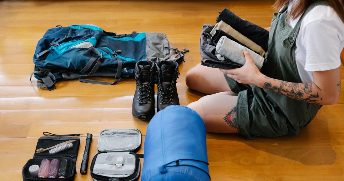 Gear on a kitchen scale next to a packed rucksack.