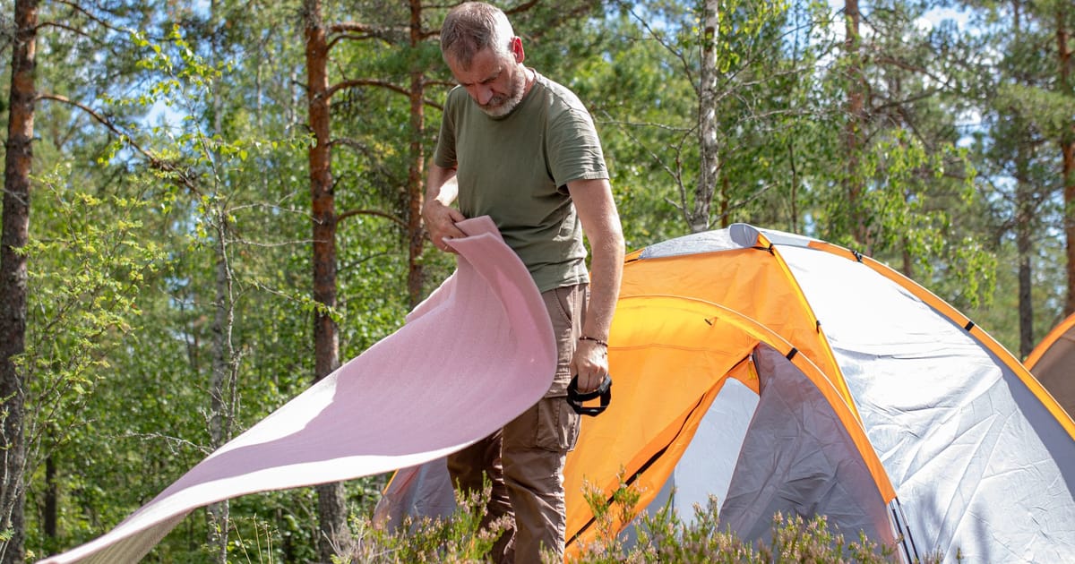 A tent drying on a line in a garden.