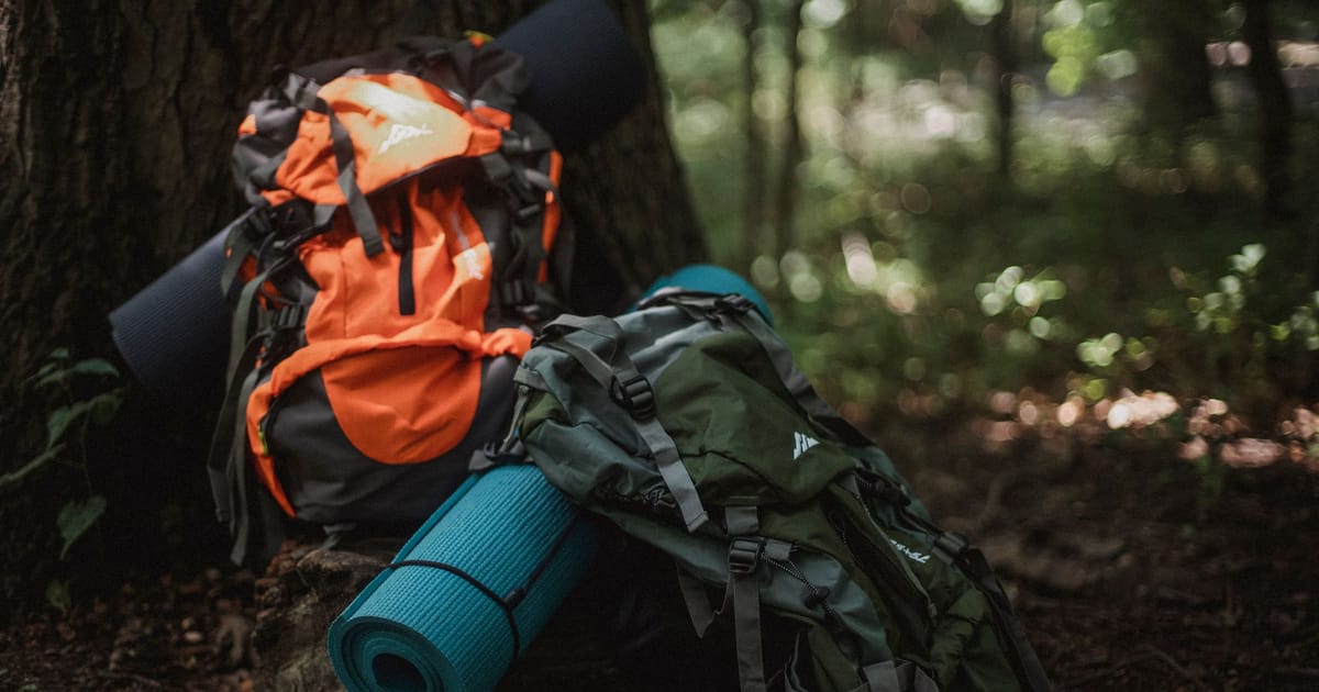 An open backpack with gear laid out ready to load.